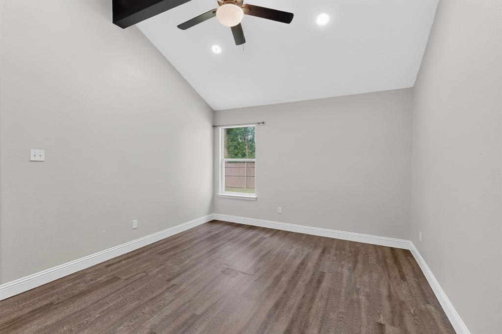 7729 Misty Ridge Drive North Fort Worth, TX 76137 - Photo 11 of 30 wooden floor in an empty room with a window