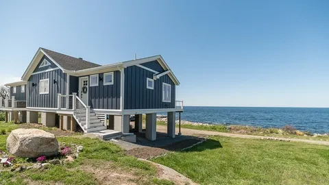 a front view of a house with a yard balcony