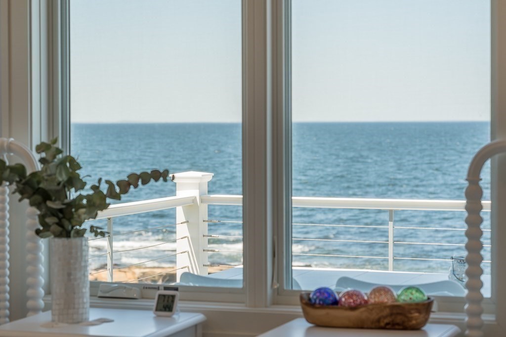 14 Sunset Point Road Gloucester, MA 01930 - Photo 4 of 40 a view of a balcony with a chair and a potted plant