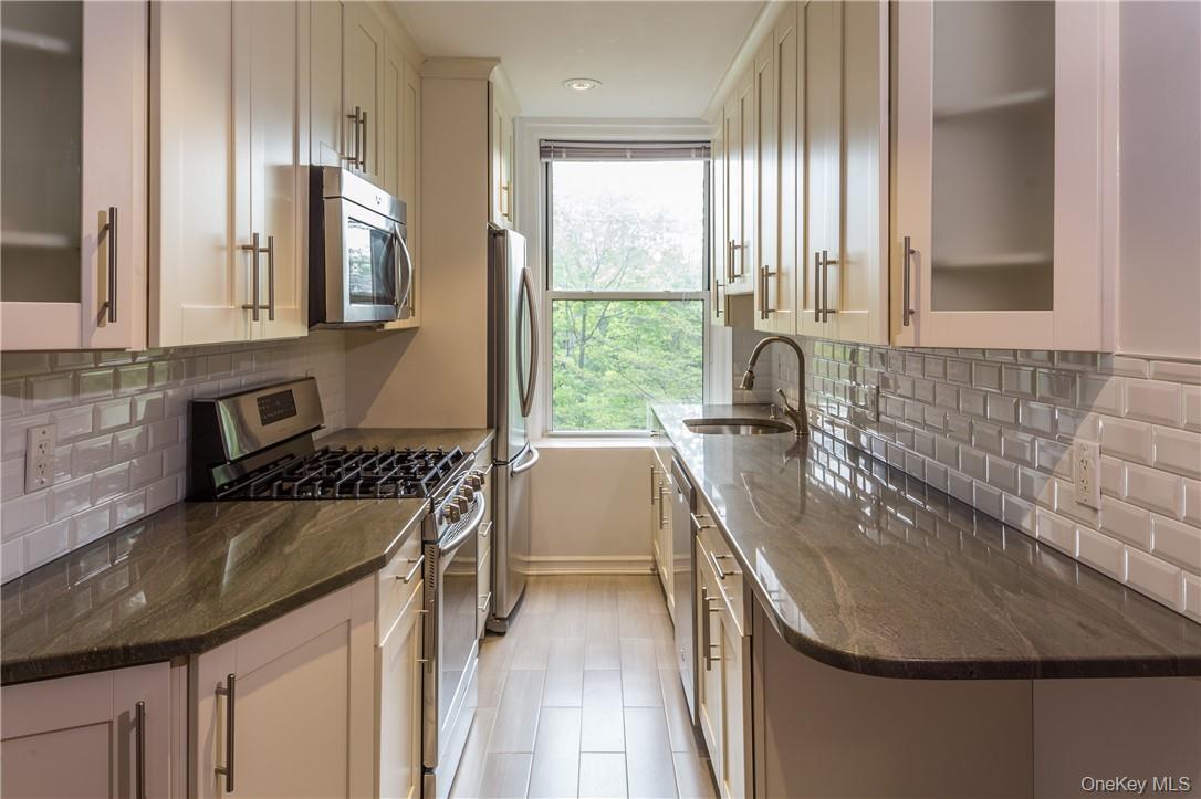 64 Sagamore Road, Unit H3 Bronxville, NY 10708 - Photo 5 of 12 View of the Kitchen featuring granite countertops, stainless steel appliances and tile backsplash.
