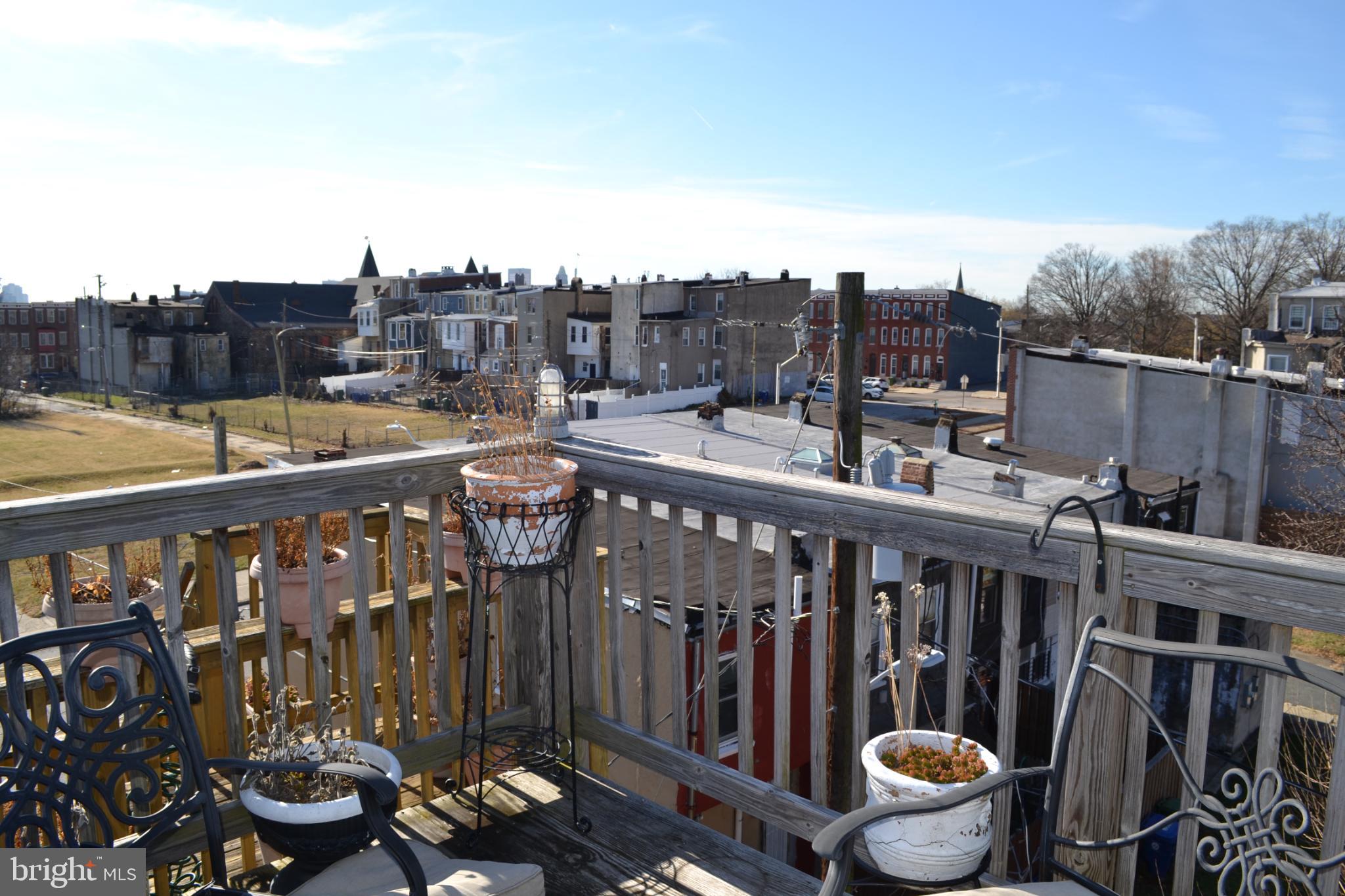 1410 North Bond Street Baltimore, MD 21213 - Photo 21 of 26 a view of a balcony with wooden chairs and floor