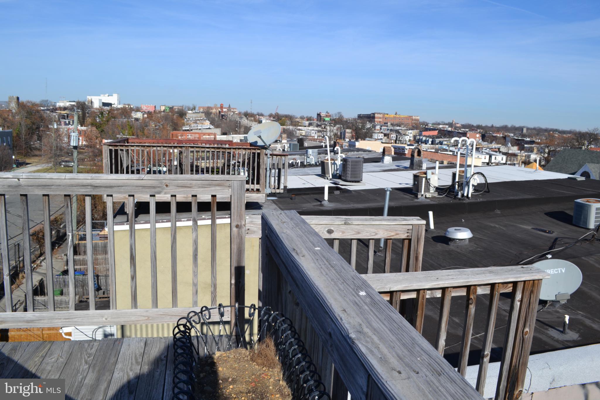 1410 North Bond Street Baltimore, MD 21213 - Photo 23 of 26 a view of a balcony with wooden floor and city view