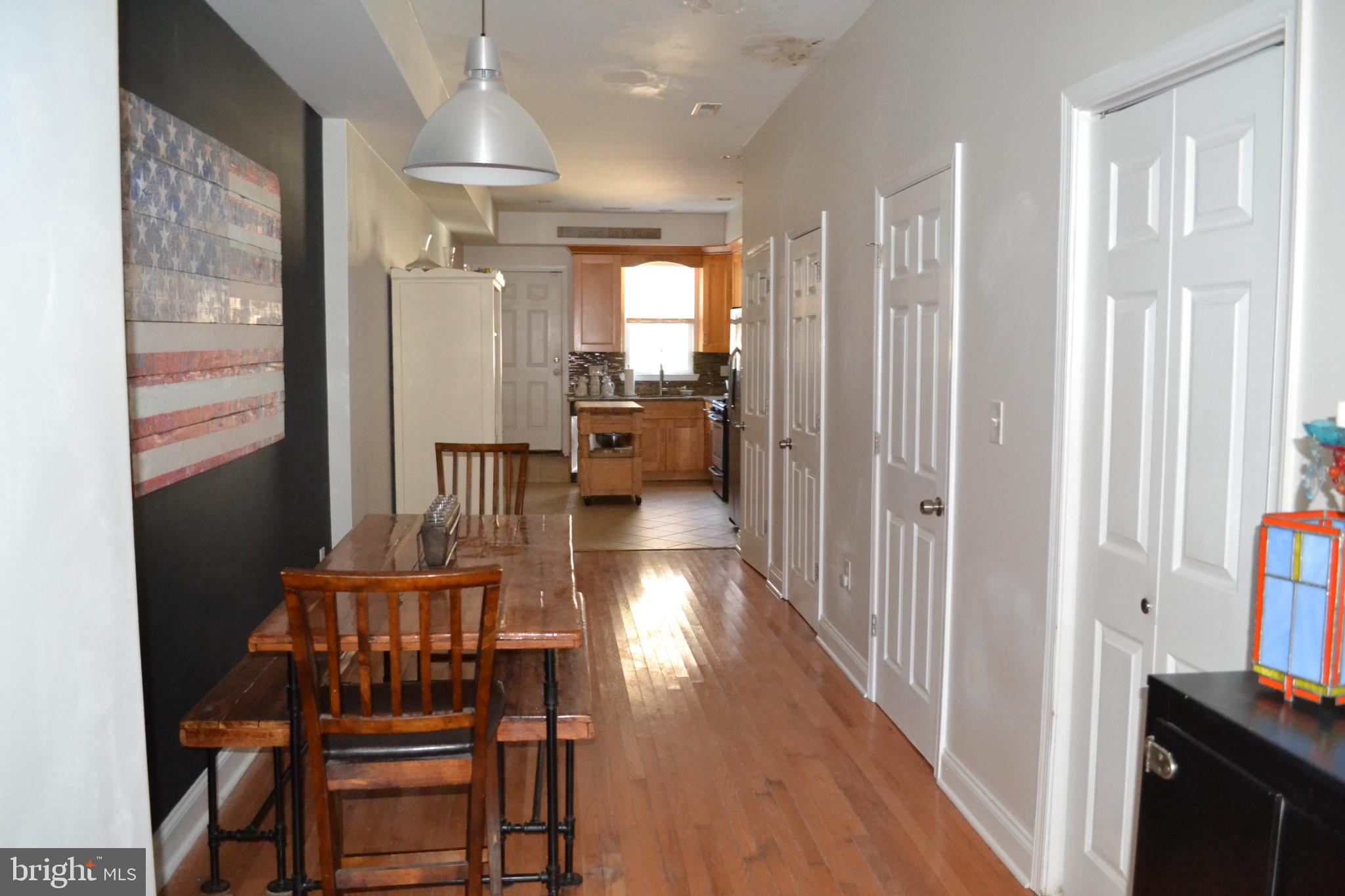 1410 North Bond Street Baltimore, MD 21213 - Photo 5 of 26 a hallway with wooden floor furniture and a bathroom