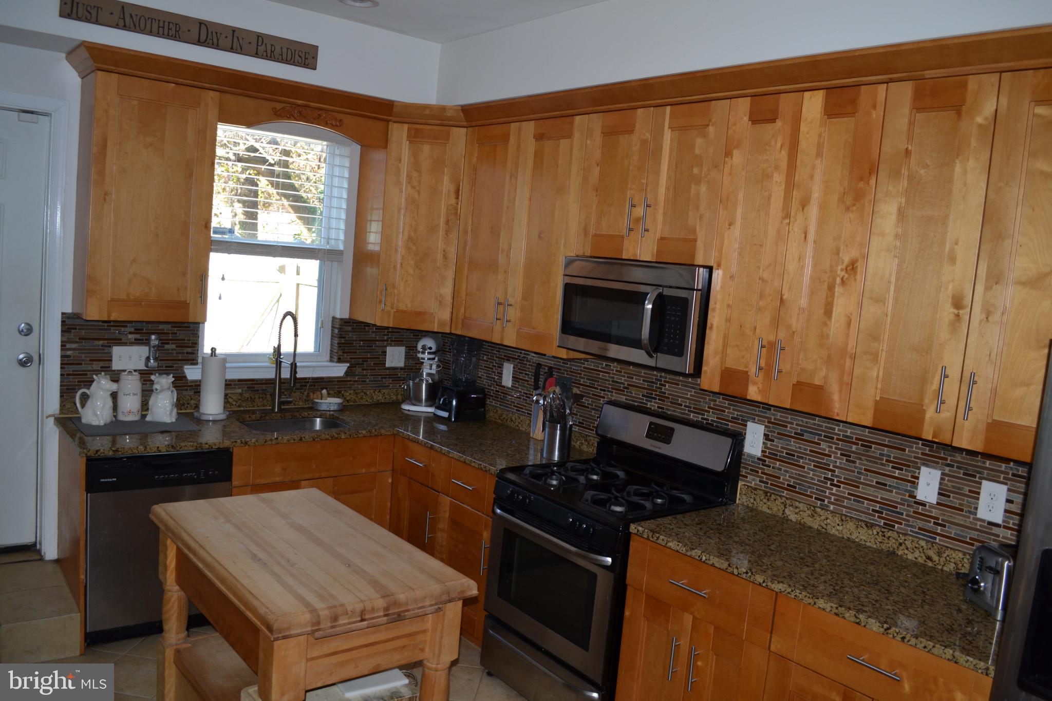 1410 North Bond Street Baltimore, MD 21213 - Photo 9 of 26 a kitchen with a stove and a microwave