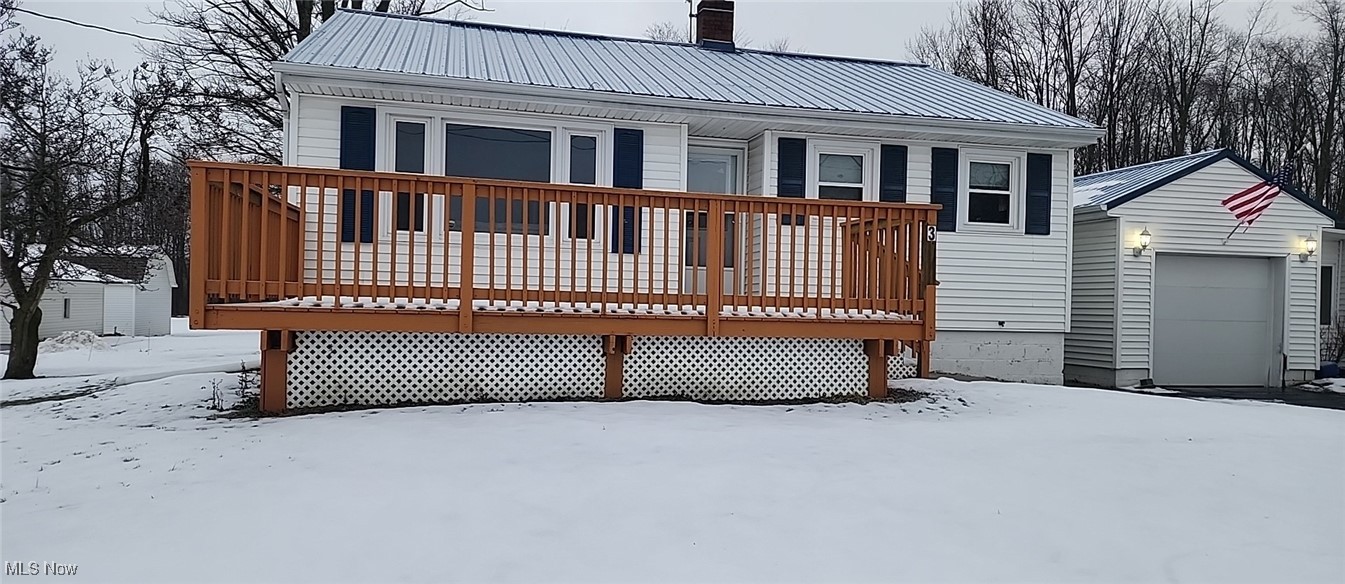 3113 Hague Road Orwell, OH 44076 - Photo 5 of 23 Snow covered rear of property featuring a garage and a wooden deck