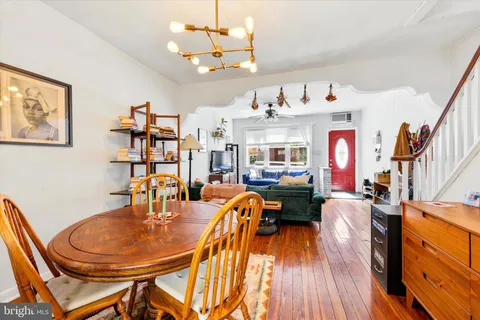 a living room with fireplace furniture and a wooden floor