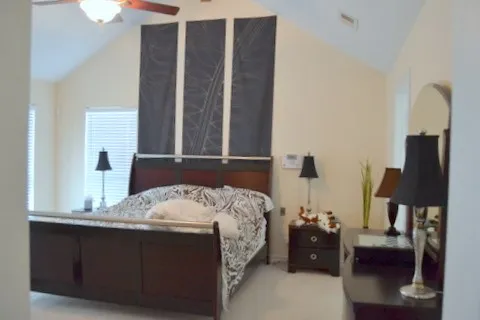 a bedroom with a bed and a window