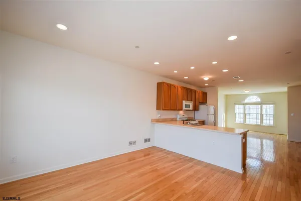 a view of a kitchen with a sink and wooden floor