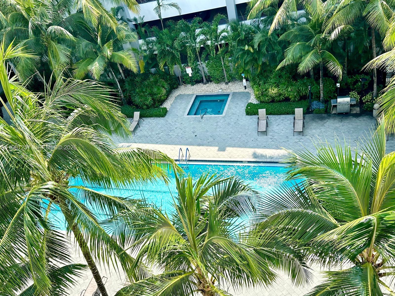 1660 Renaissance Commons Boulevard, Unit 2606 Boynton Beach, FL 33426 - Photo 24 of 26 a view of a backyard with plants