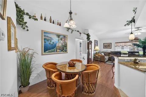 a dining room with furniture and wooden floor