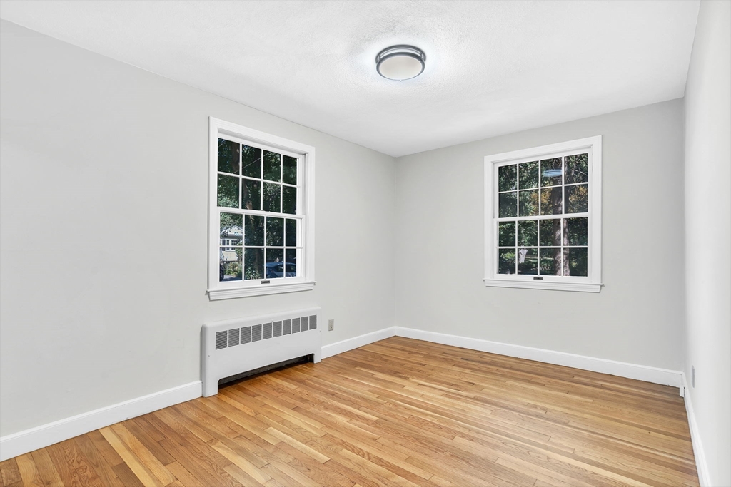 35 Arrowhead Road Concord, MA 01742 - Photo 16 of 23 a view of an empty room with wooden floor and windows