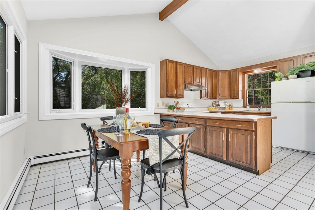 35 Arrowhead Road Concord, MA 01742 - Photo 6 of 23 a open dining room with stainless steel appliances a kitchen island a stove a table and chairs