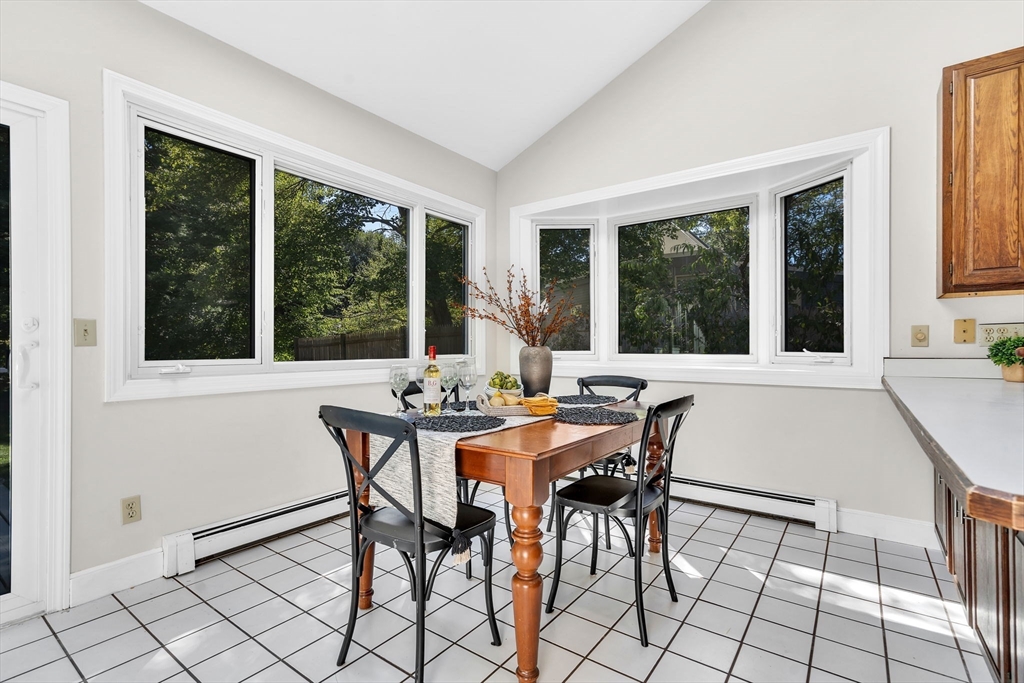 35 Arrowhead Road Concord, MA 01742 - Photo 9 of 23 a view of a dining room with furniture large windows and wooden floor