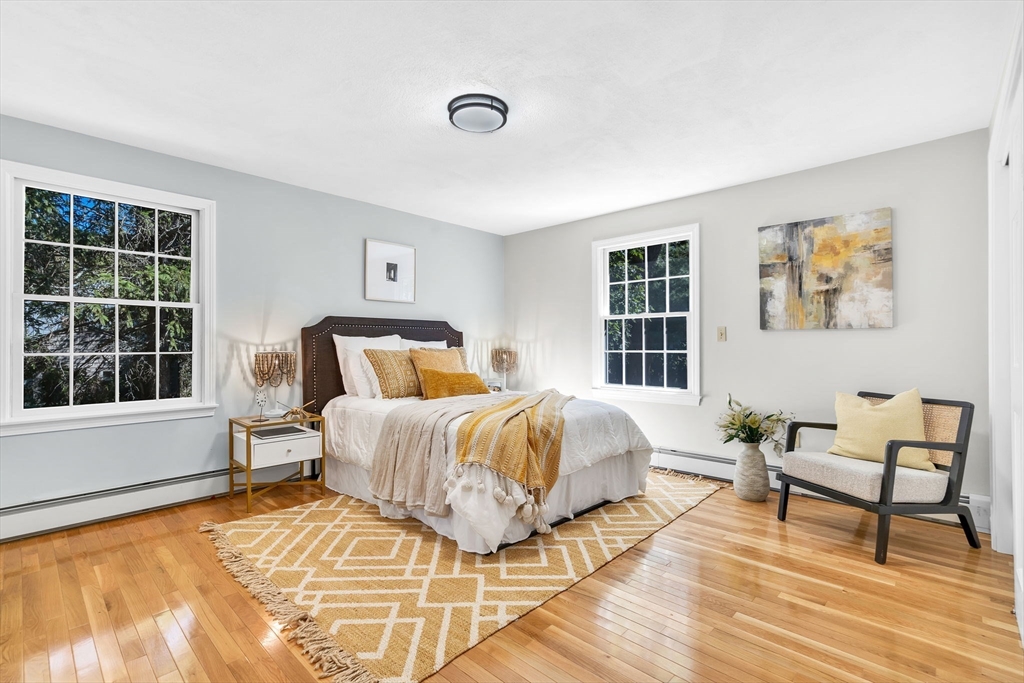 35 Arrowhead Road Concord, MA 01742 - Photo 10 of 23 a bedroom with a bed and wooden floor