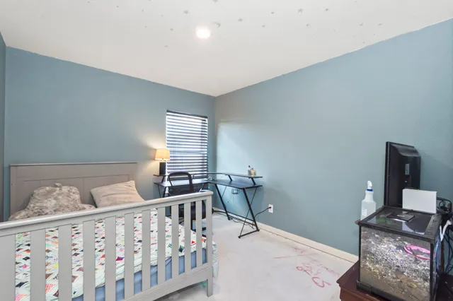 a bedroom with furniture and a window