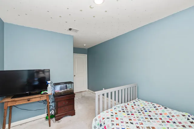 a bedroom with furniture and a flat screen tv