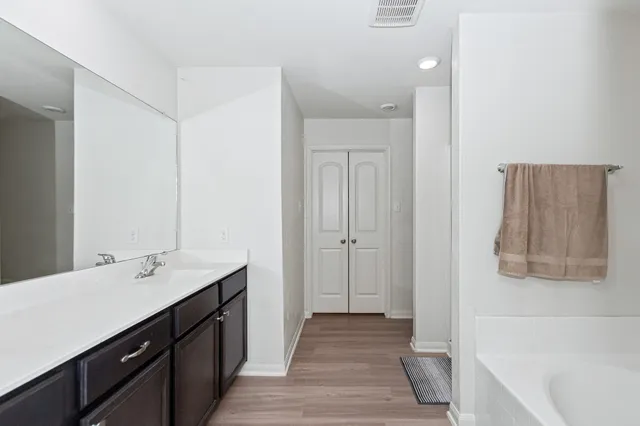 a bathroom with a double vanity sink and a bathtub