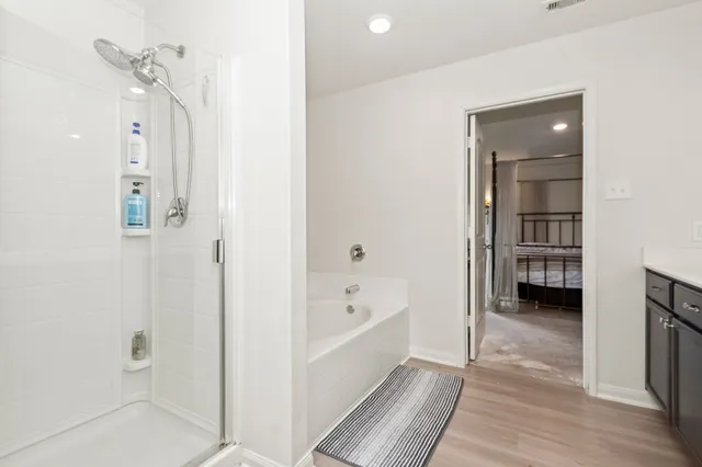 a bathroom with a bathtub and a shower