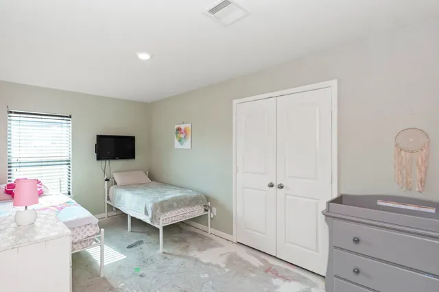 a bedroom with a bed and a chair