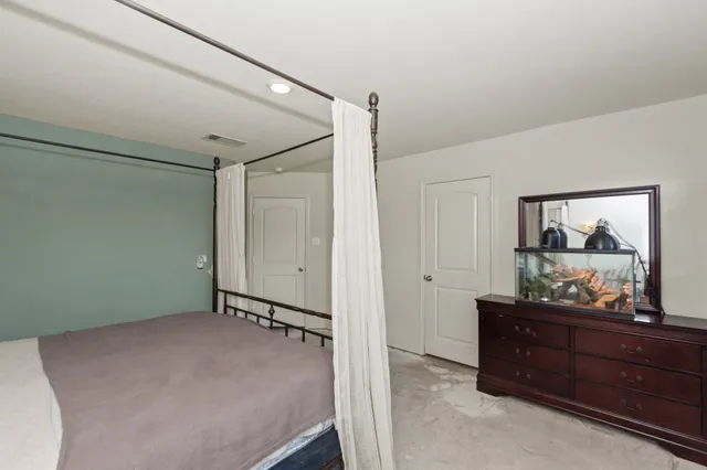 a room with a dresser and mirror