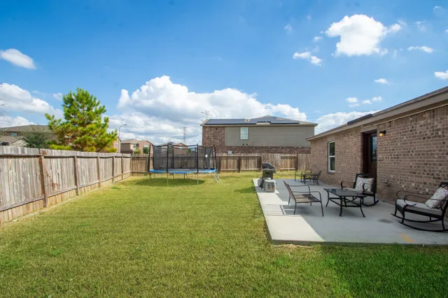 a view of a patio with table and chairs potted plants with wooden fence