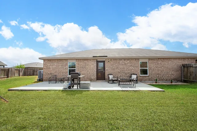 a view of house with outdoor seating area