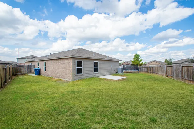 a front view of house with yard and trees