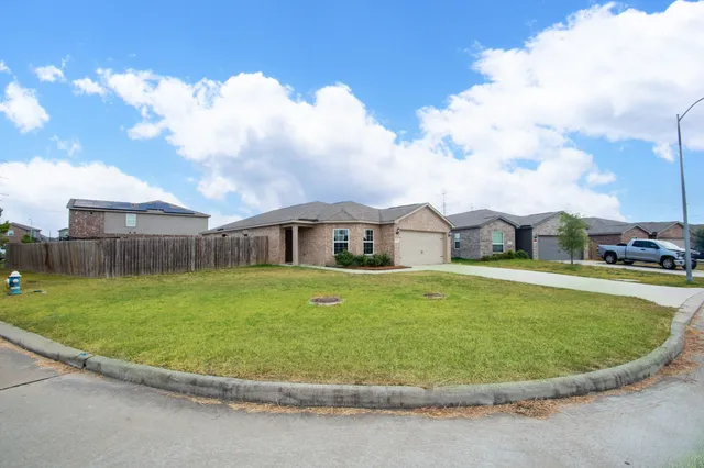 a view of a house with a swimming pool and a yard