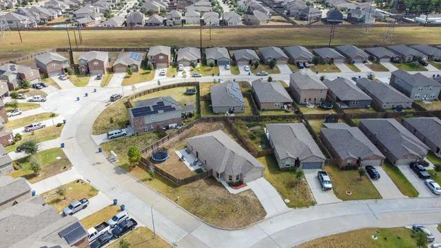 an aerial view of a swimming pool with outdoor seating