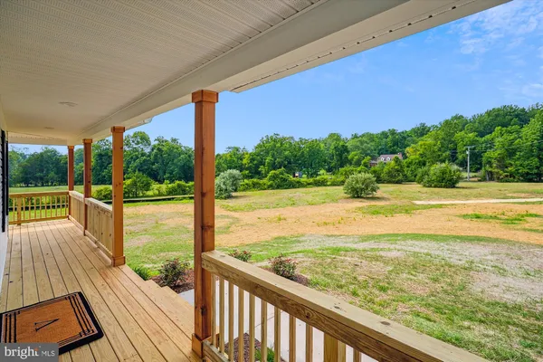 a view of a balcony with wooden floor