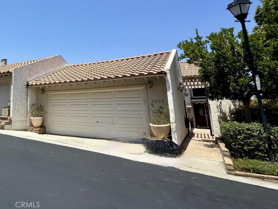Front view of entry and 2 car garage