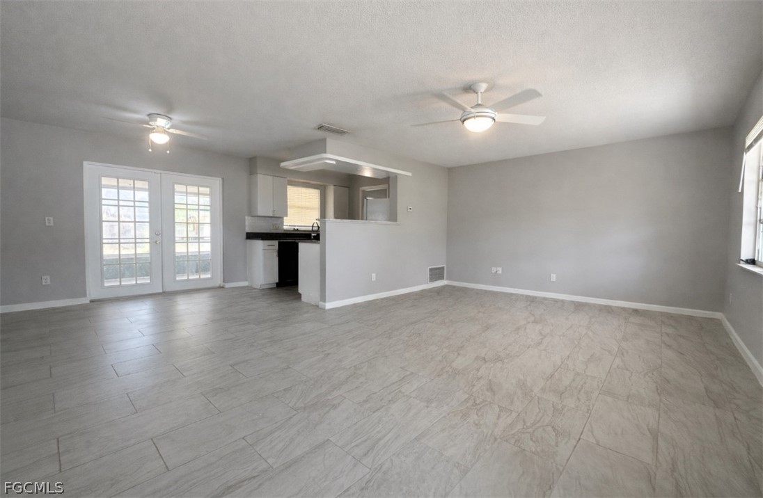 424 Cactus Circle Lehigh Acres, FL 33936 - Photo 1 of 18 an empty room with windows and cabinet