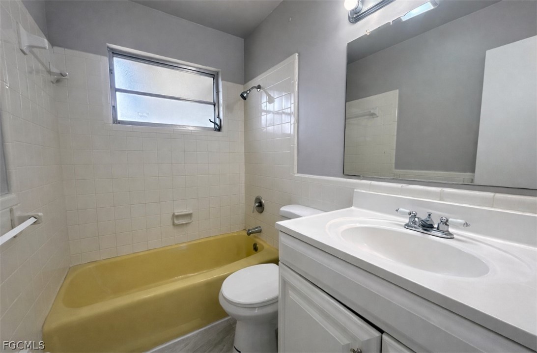424 Cactus Circle Lehigh Acres, FL 33936 - Photo 11 of 18 a bathroom with a sink mirror toilet and bathtub