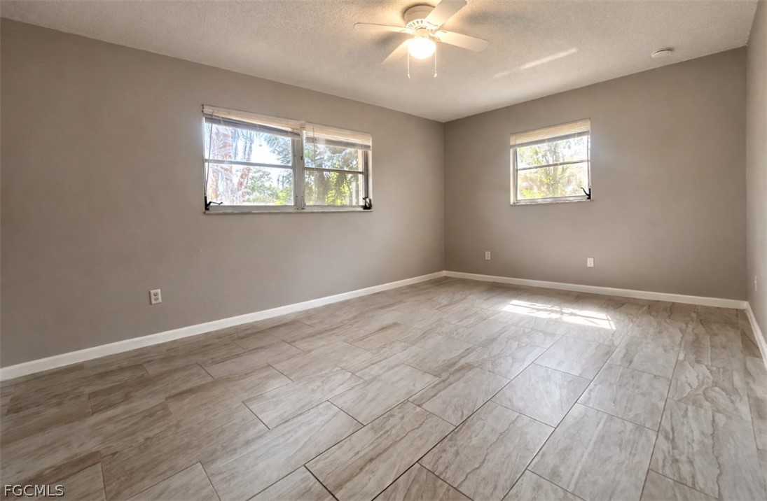 424 Cactus Circle Lehigh Acres, FL 33936 - Photo 14 of 18 a view of an empty room with a window
