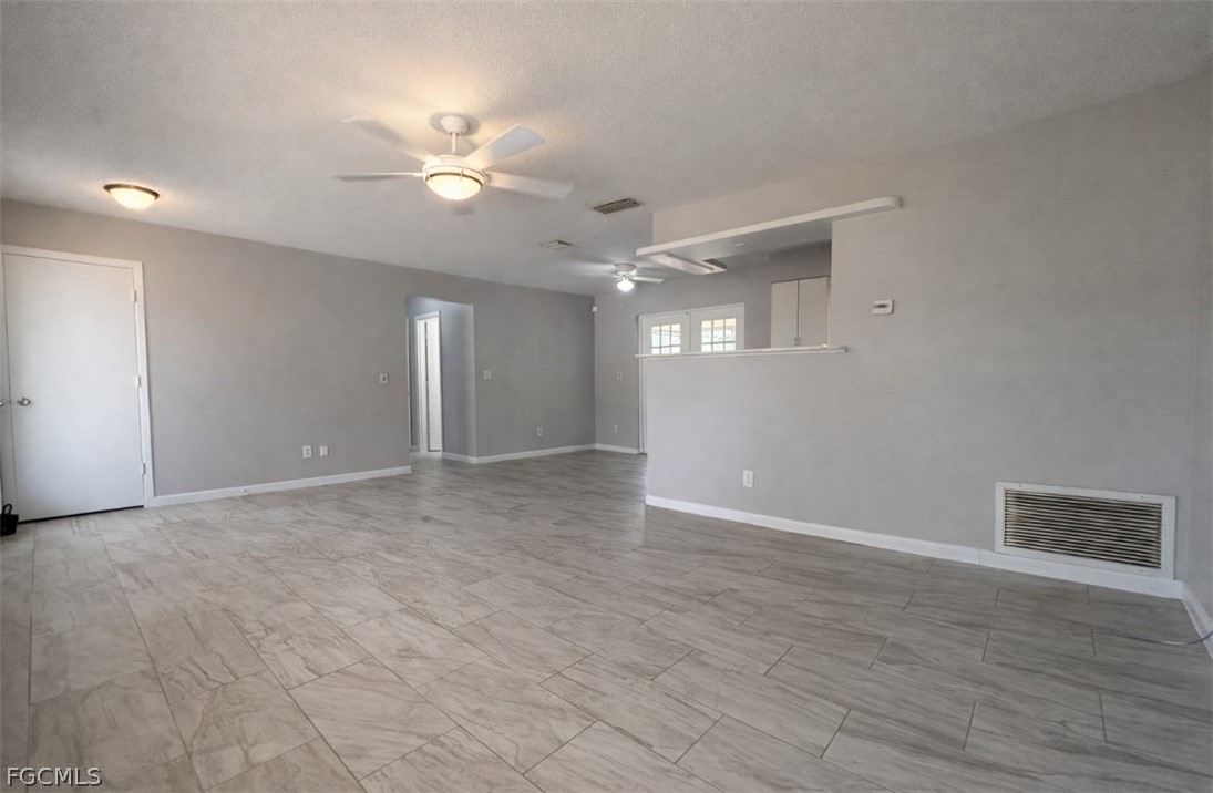 424 Cactus Circle Lehigh Acres, FL 33936 - Photo 3 of 18 a view of a livingroom with a ceiling fan