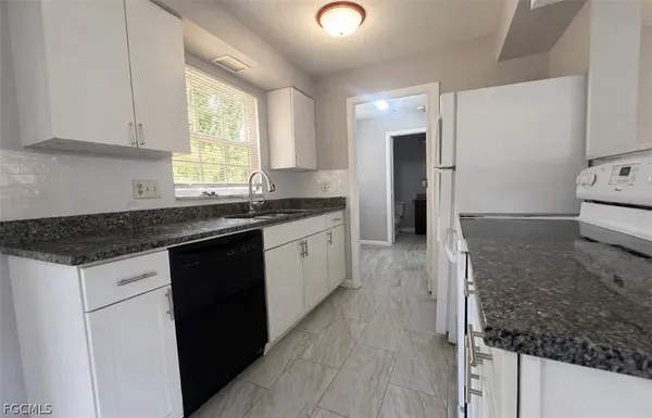 a kitchen with a sink stove and cabinets
