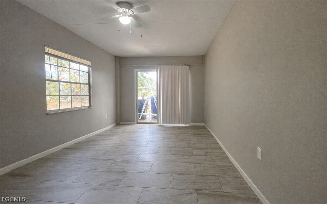 424 Cactus Circle Lehigh Acres, FL 33936 - Photo 7 of 18 wooden floor in an empty room with a window