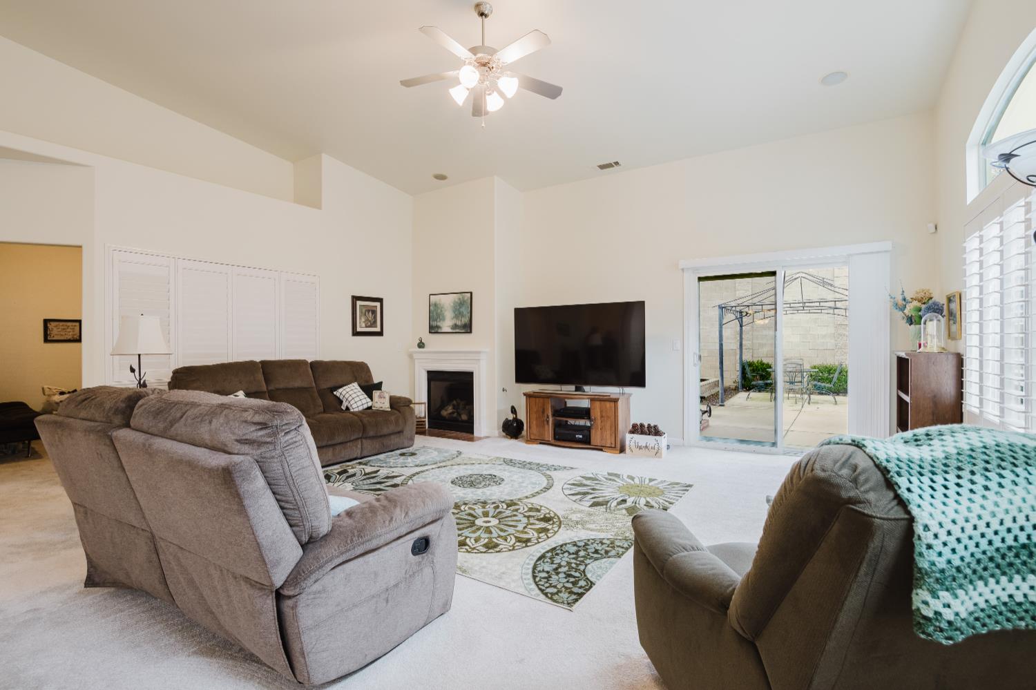 1634 Judith Way Escalon, CA 95320 - Photo 17 of 40 a living room with furniture a flat screen tv and a large window