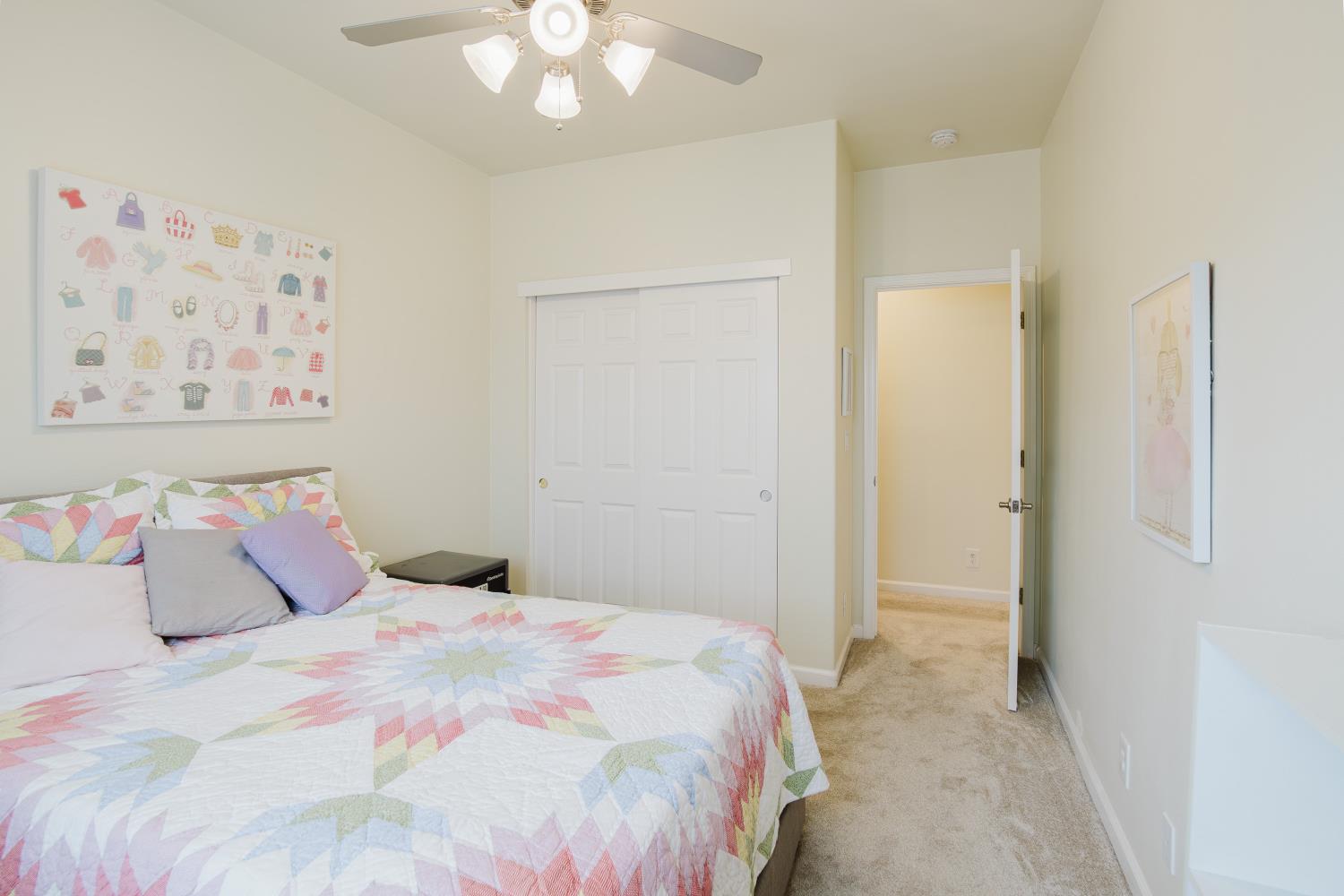 1634 Judith Way Escalon, CA 95320 - Photo 28 of 40 a bedroom with a large bed and a chandelier