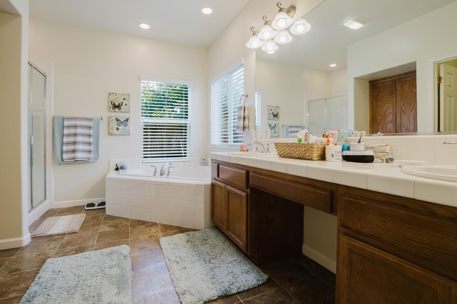 1634 Judith Way Escalon, CA 95320 - Photo 32 of 40 a bathroom with a tub sink and mirror