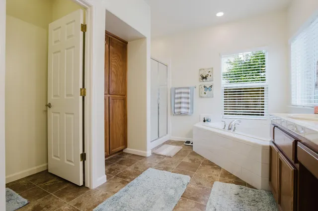 a spacious bathroom with a bathtub and a shower