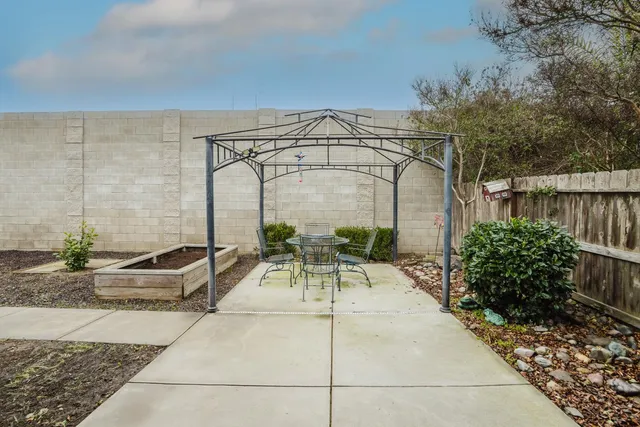 a view of swimming pool with outdoor seating and plants
