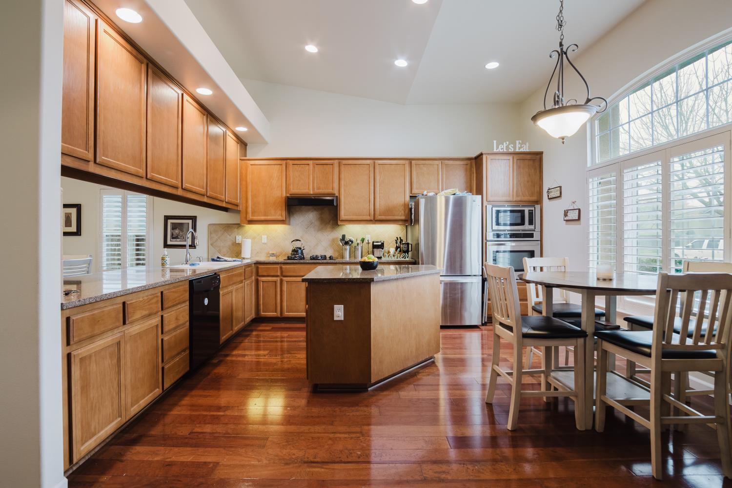 1634 Judith Way Escalon, CA 95320 - Photo 5 of 40 a large kitchen with lots of counter space wooden floor and stainless steel appliances