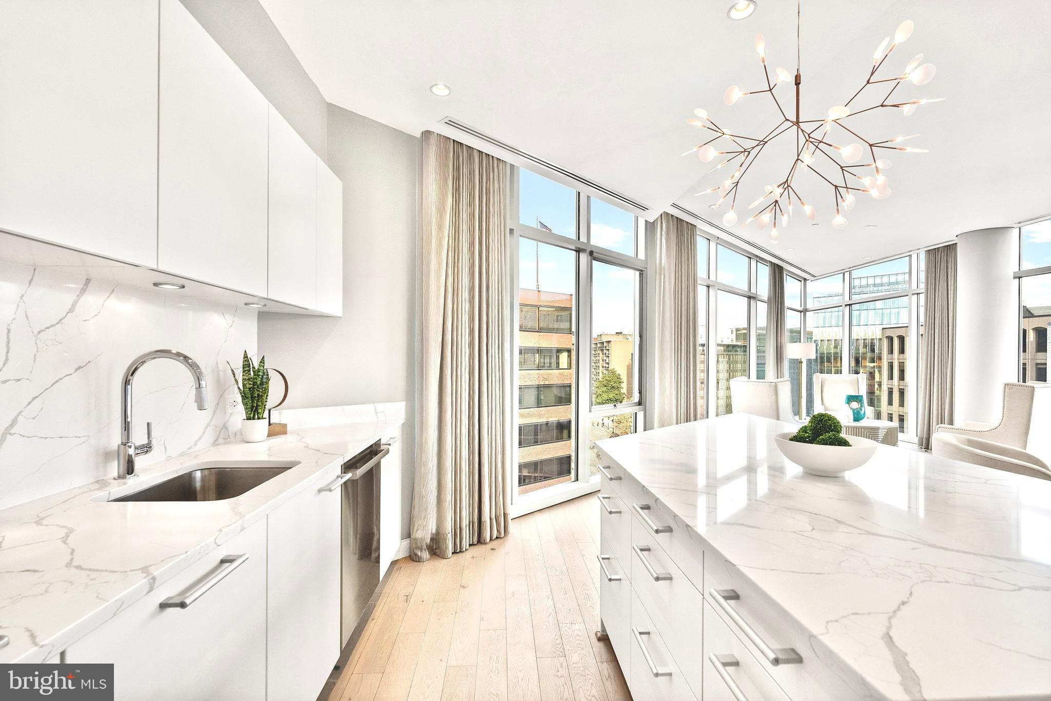 1177 22nd Street Northwest, Unit 7D Washington, DC 20037 - Photo 11 of 29 a large white kitchen with a large window a sink and stainless steel appliances