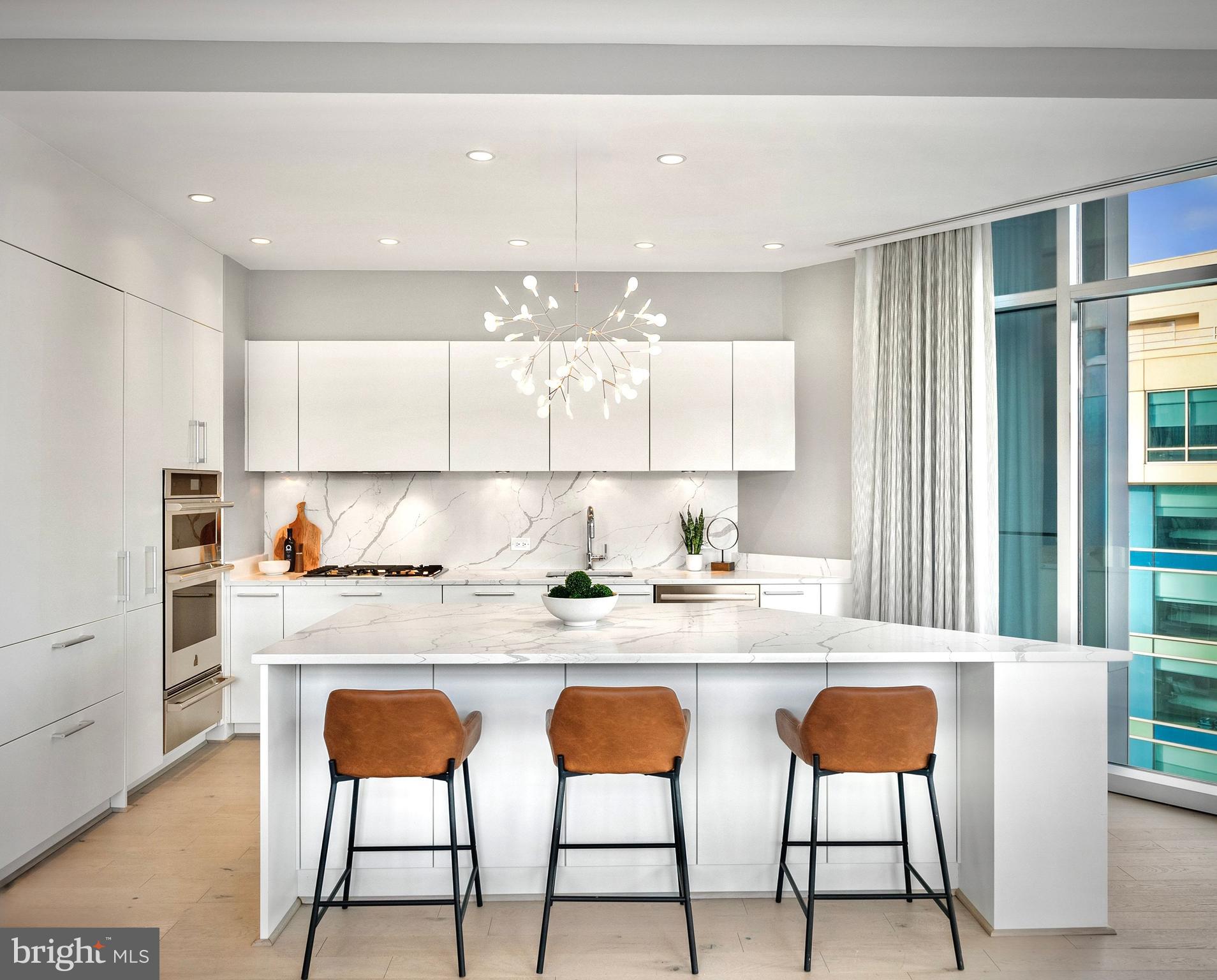 1177 22nd Street Northwest, Unit 7D Washington, DC 20037 - Photo 9 of 29 a kitchen with stainless steel appliances granite countertop a stove a sink and a refrigerator