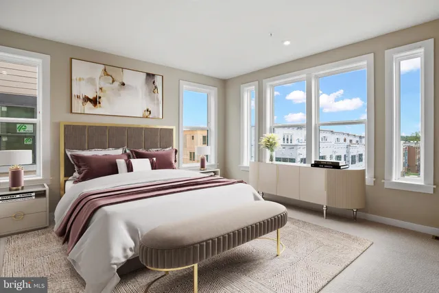 a bedroom with a large bed and a large window