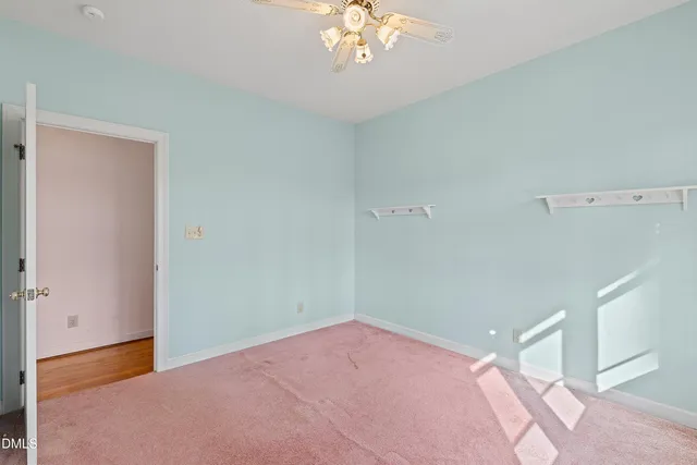 a view of a livingroom with a chandelier fan