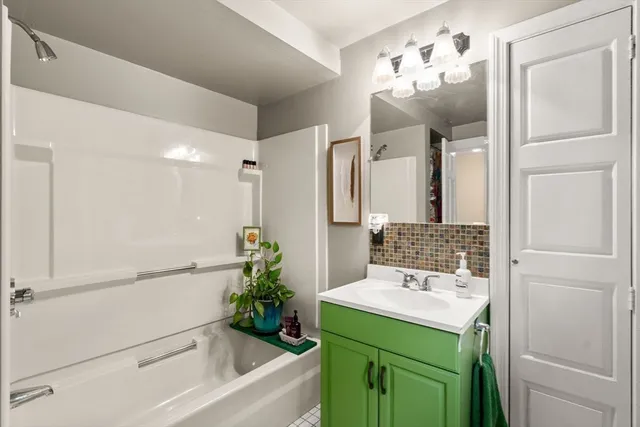 a bathroom with a sink a mirror and a shower