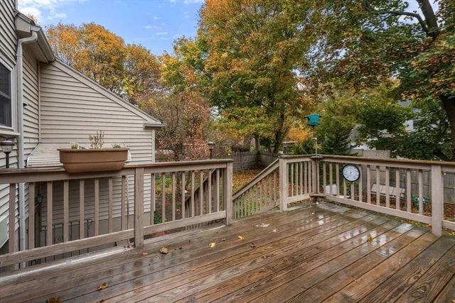 a view of a deck with two chairs and wooden floor