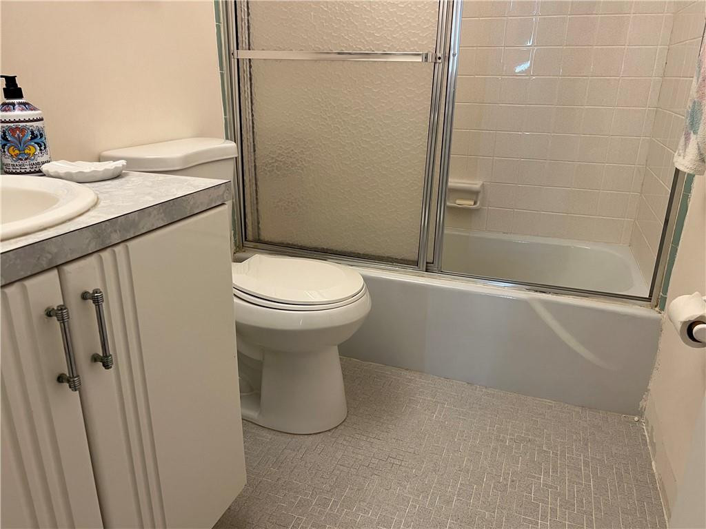 2100 Northeast 38th Street, Unit 124 Lighthouse Point, FL 33064 - Photo 11 of 30 a bathroom with a sink a toilet and shower